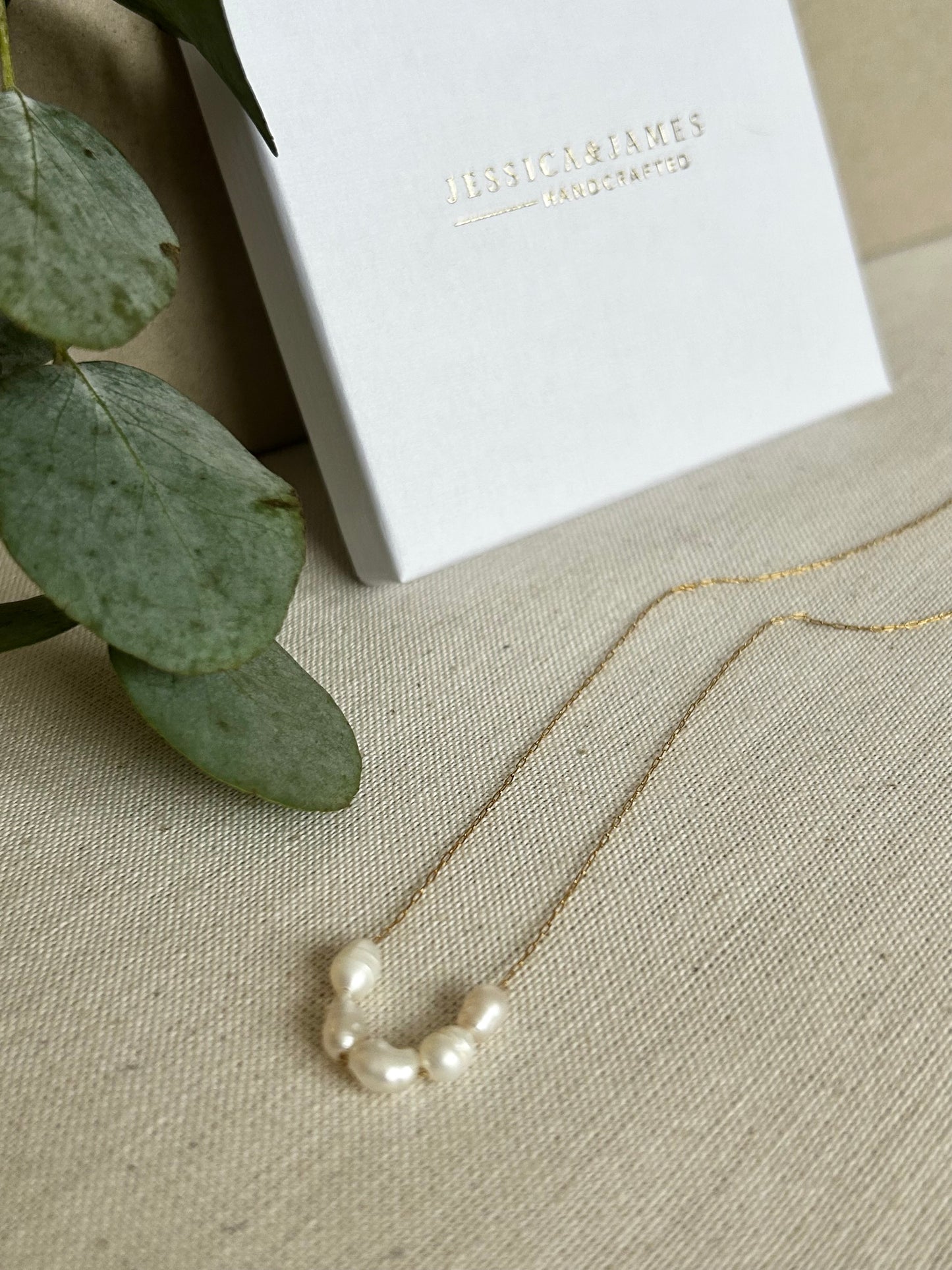 Floating pearl necklace in gold