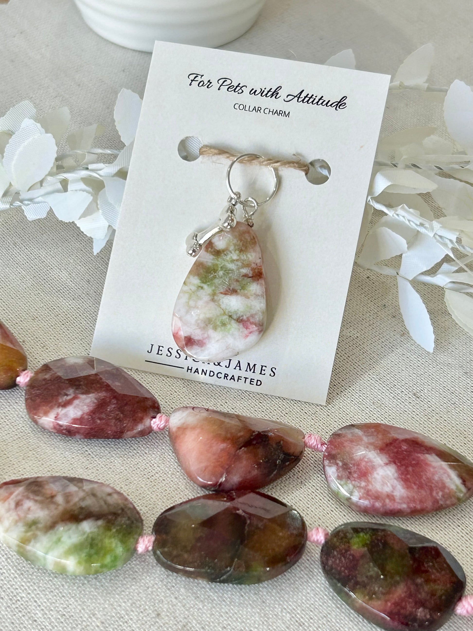 A multi-colored Agate crystal pet collar charm Jessica & James , attached to a silver-toned bone with a double split ring.
