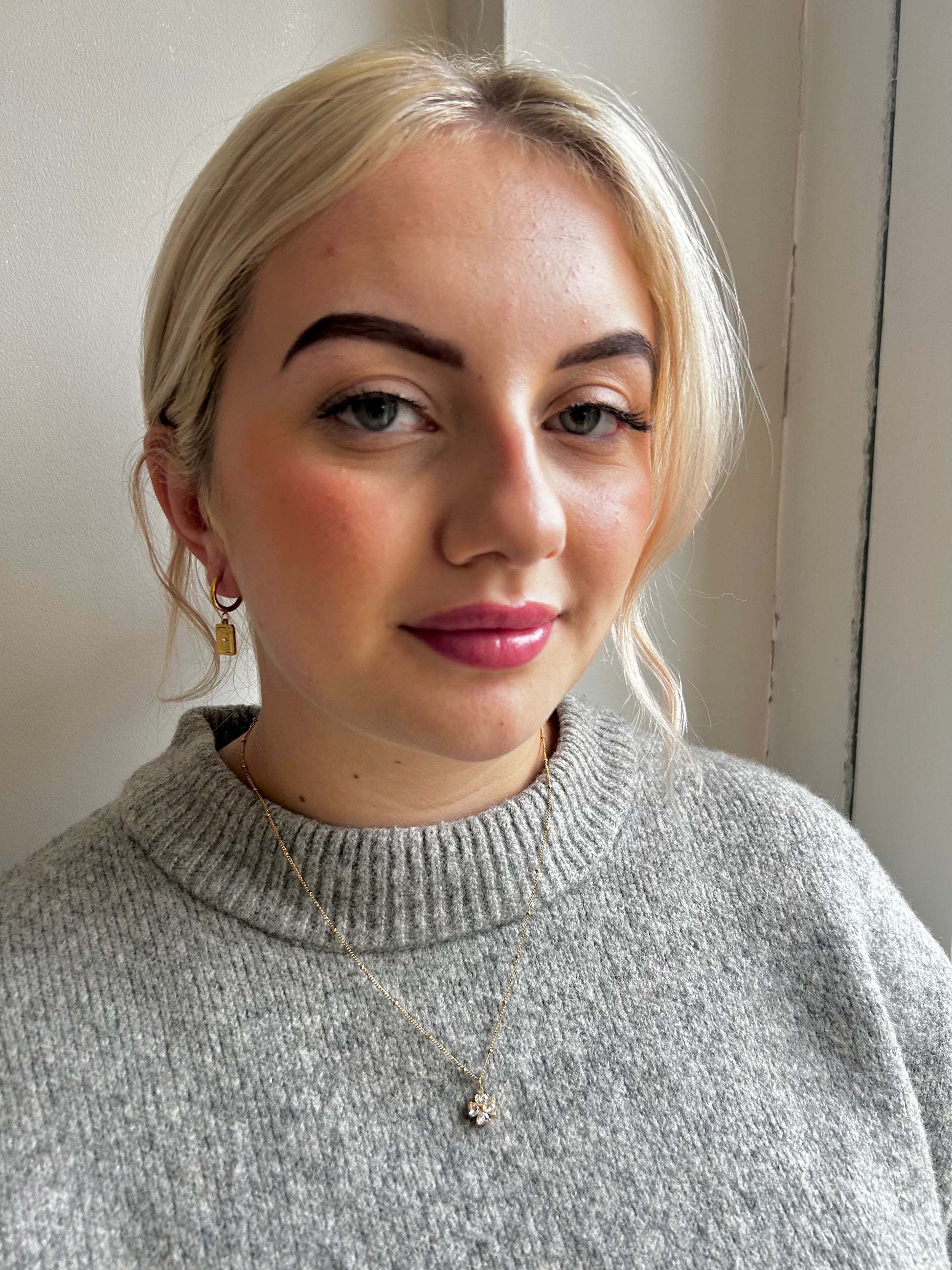 Woman wearing Jessica and James gold jewellery