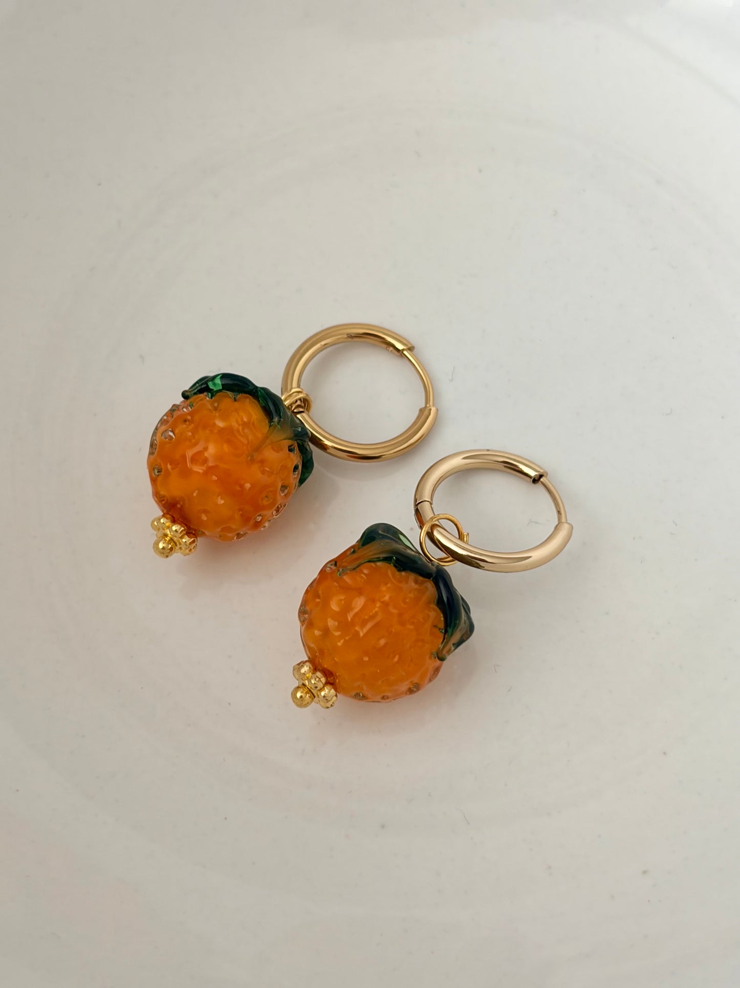 Orange huggie hoop earrings