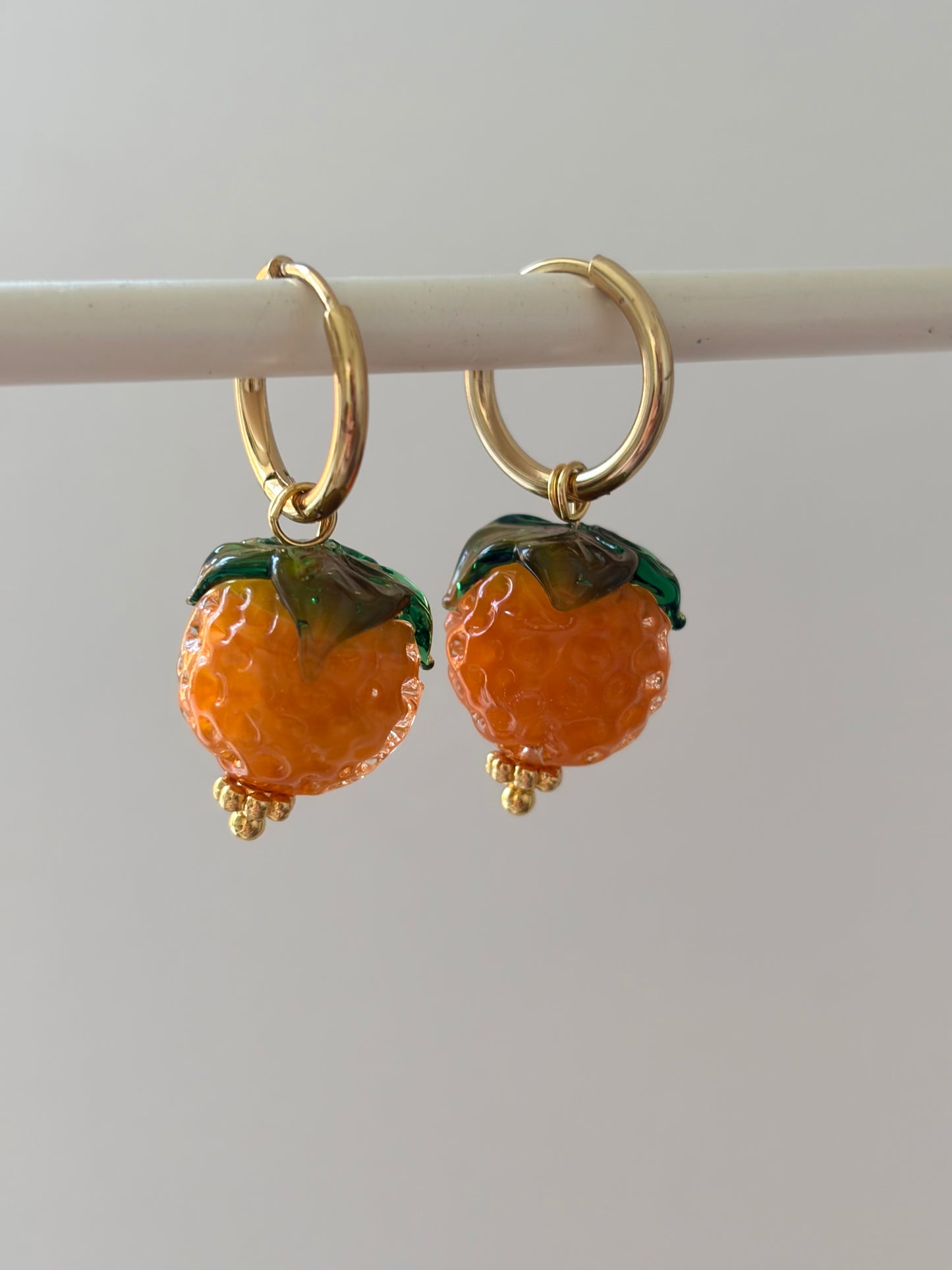 Orange huggie hoop earrings
