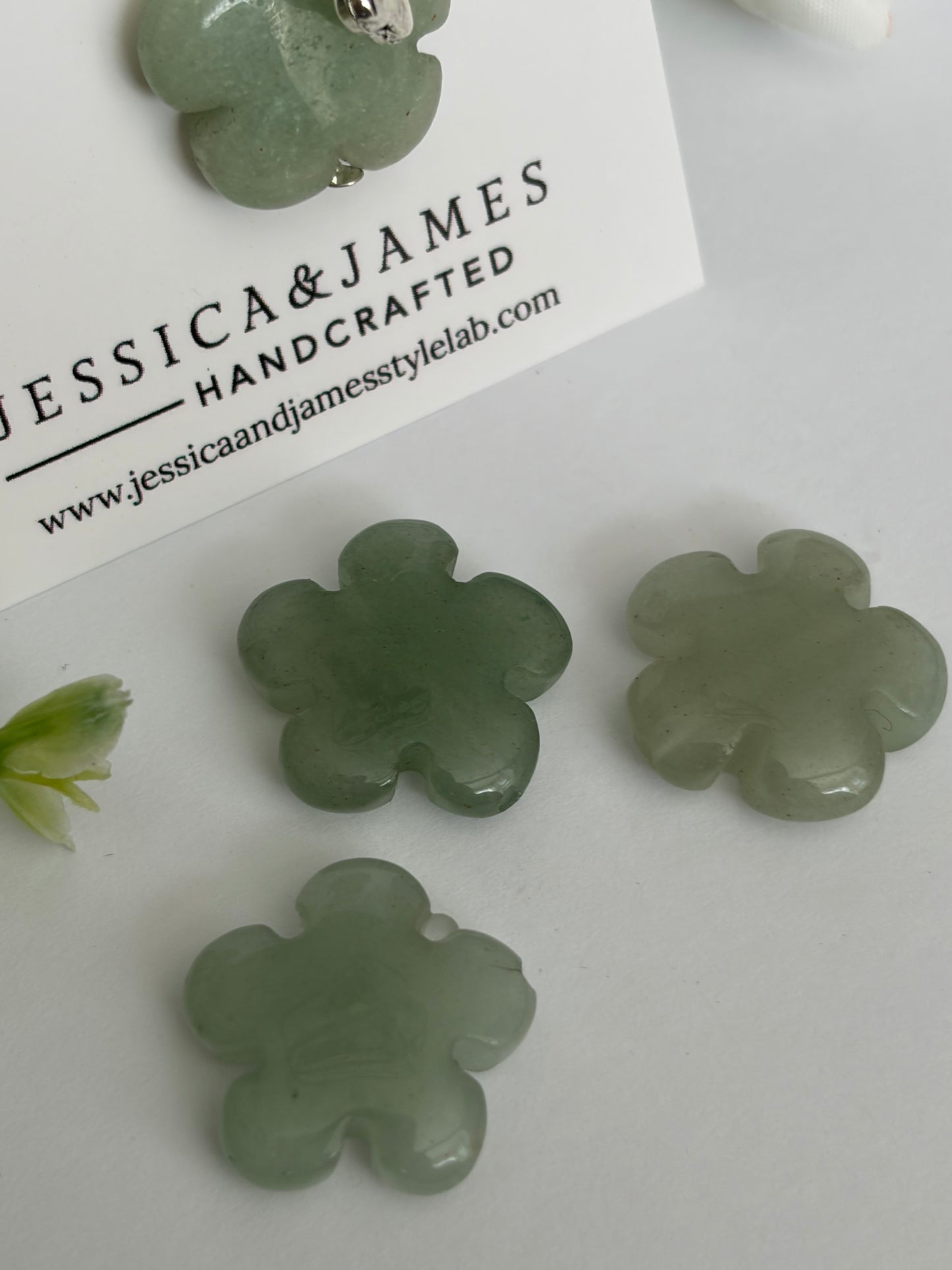 Green aventurine dog collar charm, close-up of natural green gemstone flower
