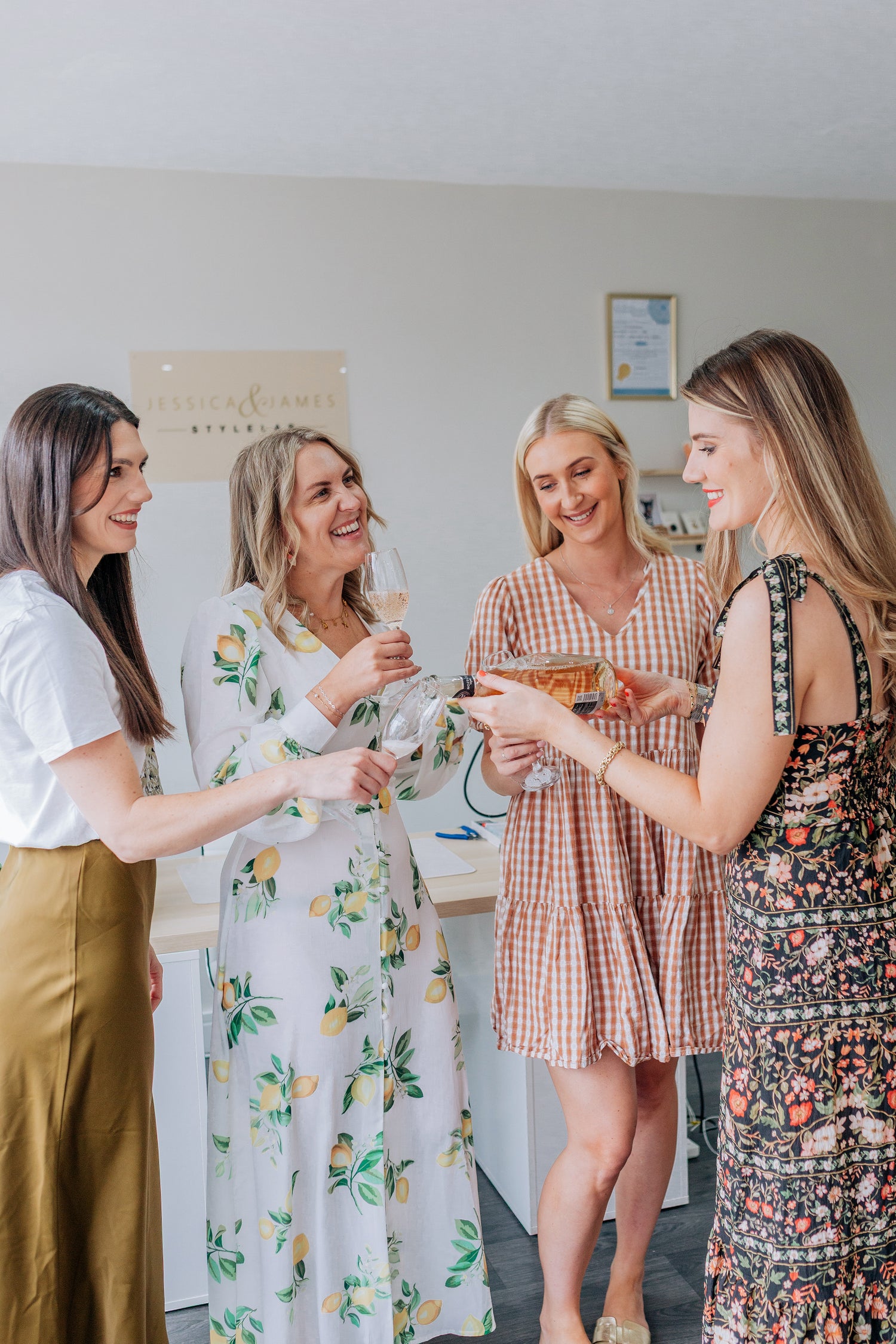 Four women socializing and drinking whilst making their own welded bracelets