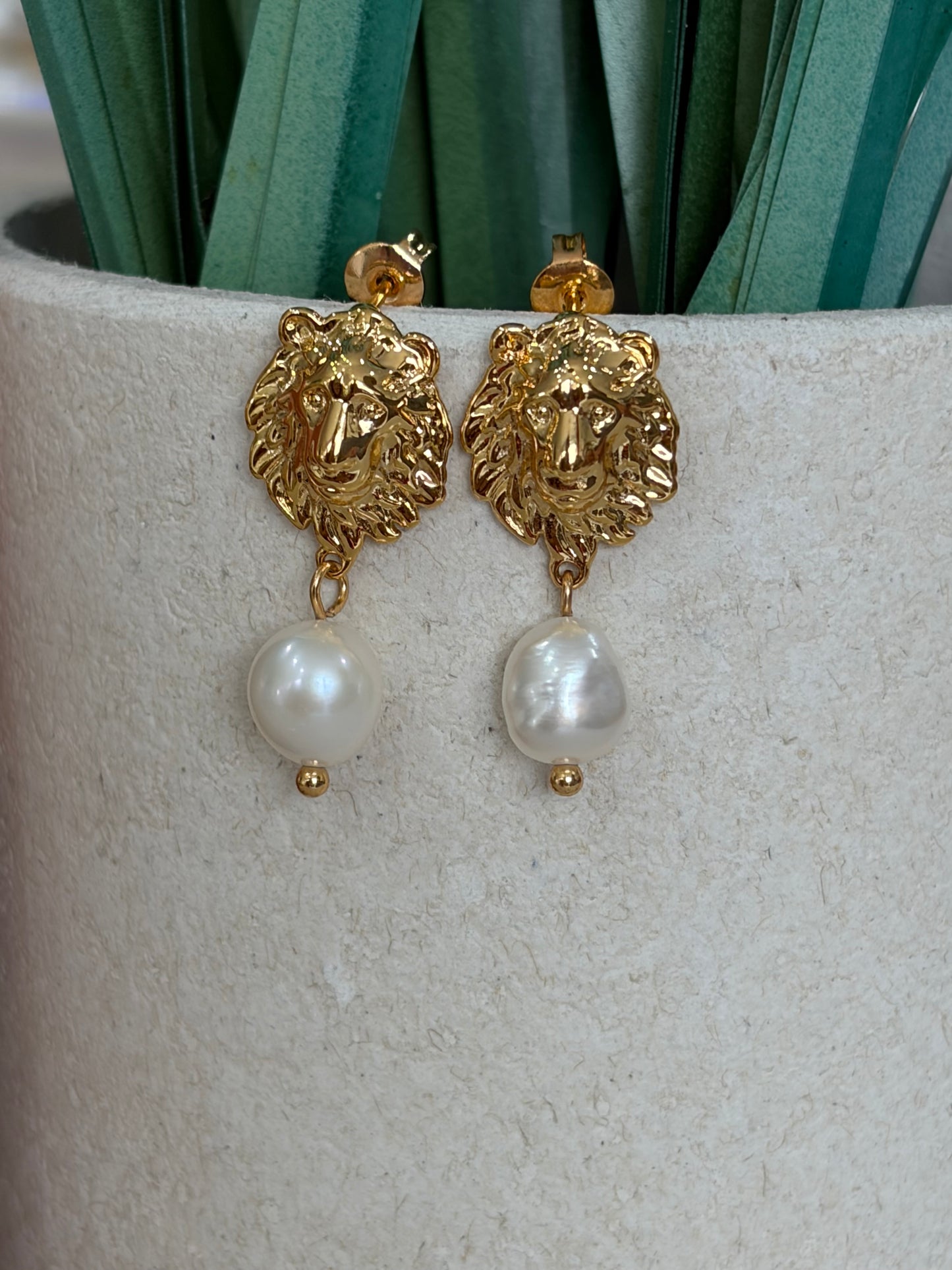 Natural pearl earrings with intricate lions head detailling